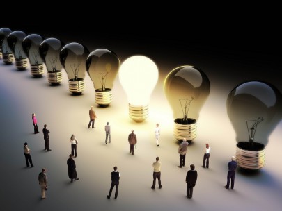 A glowing light bulb standing out among dark bulbs with small people figures around, symbolizing intuitive insight.